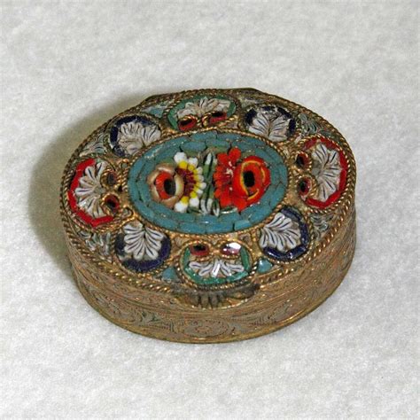 small metal antique pill box with coat of arms|old fashioned ornate pill containers.